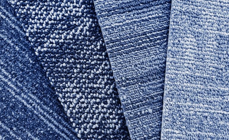 A close-up of blue fabric, illustrating its texture, relevant to carpet tile flooring services offered in Chicago, IL.