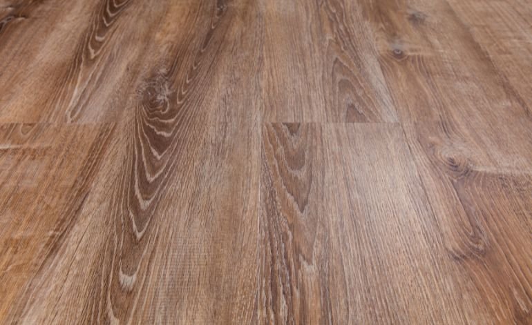 Detailed close-up of a wood floor, highlighting the laminate surface, linked to flooring services in Chicago, IL.